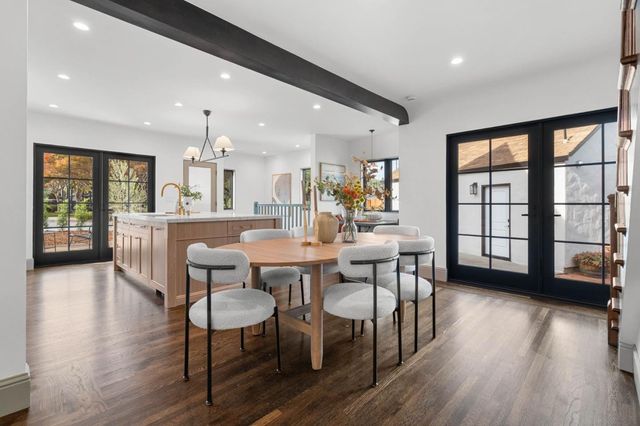 a dining room with furniture and wooden floor