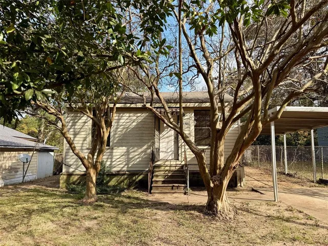 a backyard of a house with large trees
