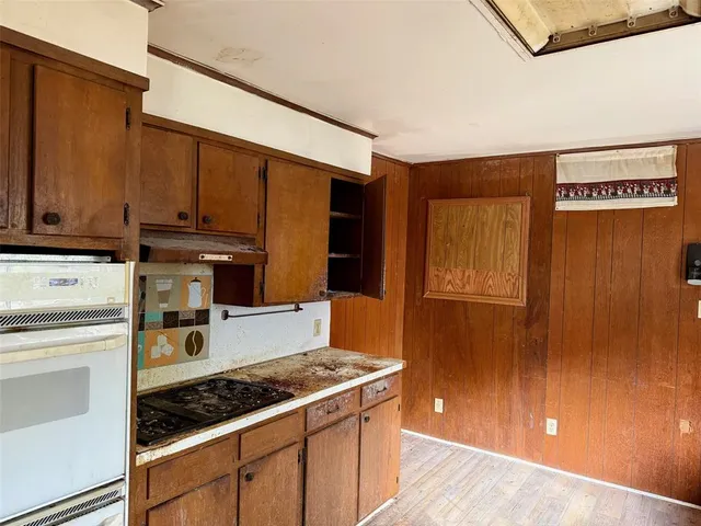 a kitchen with stainless steel appliances granite countertop a stove and a refrigerator