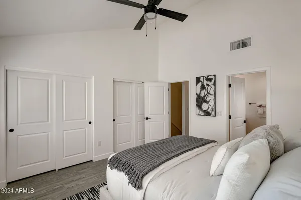 a bedroom with a bed and a chandelier