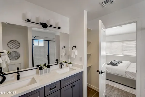 a bathroom with a double vanity sink mirror and toilet