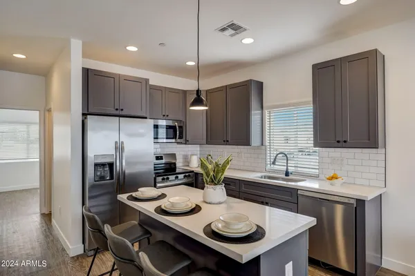 a kitchen with refrigerator and a sink
