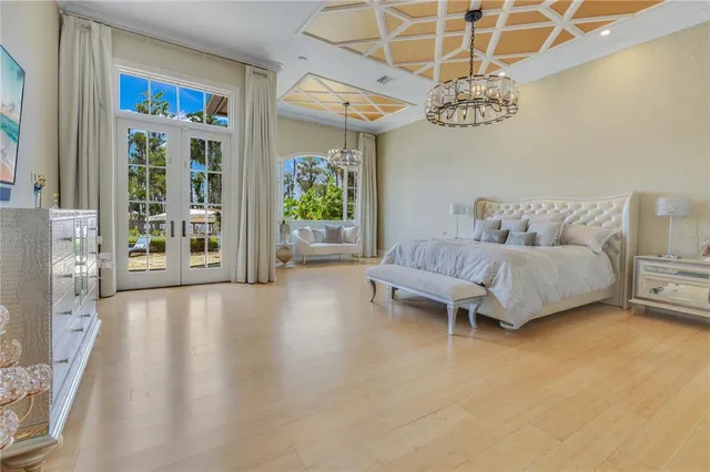 a bedroom with a bed and a chandelier