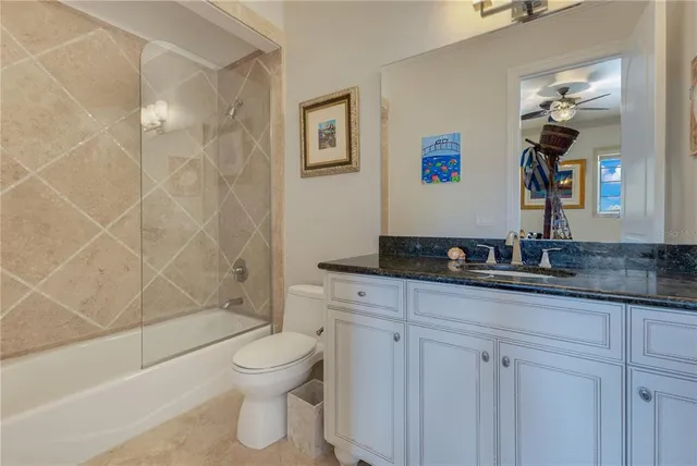 a view of a swimming pool with couches and lounge chairs