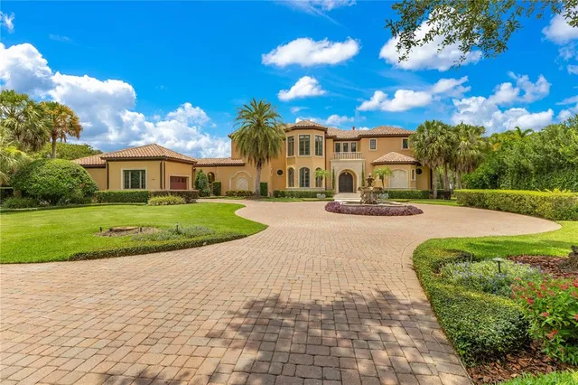 a dining room with wooden floor a chandelier a glass table and chairs