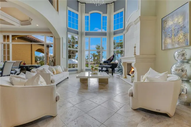 a dining room with furniture a chandelier and window