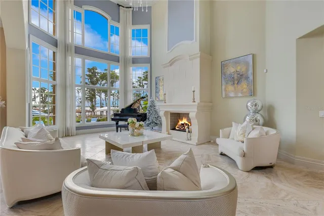 a kitchen with stainless steel appliances granite countertop a sink a stove a refrigerator a oven a dining table and chairs