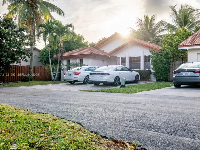 a front view of a house with a garden and pathway