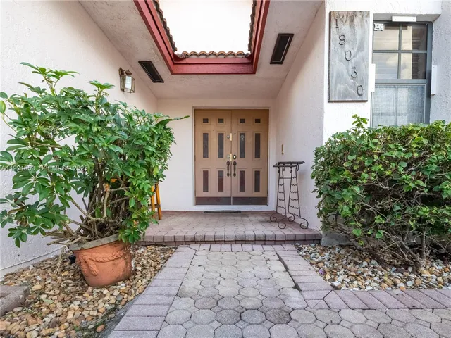 a view of a pathway with potted plants