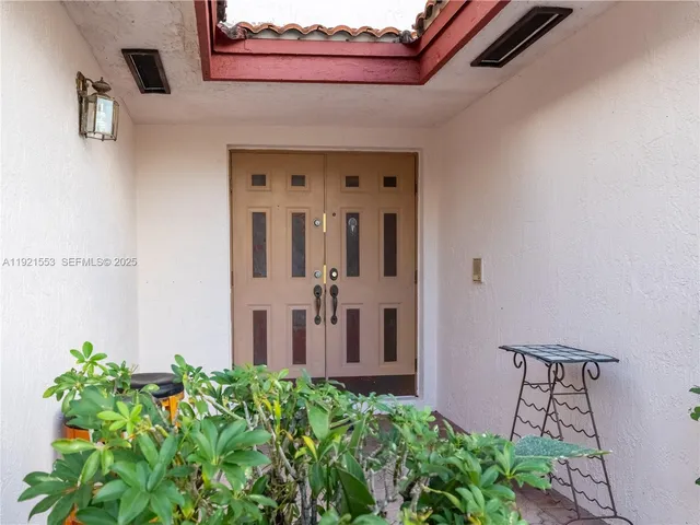 front view of a house with potted plants