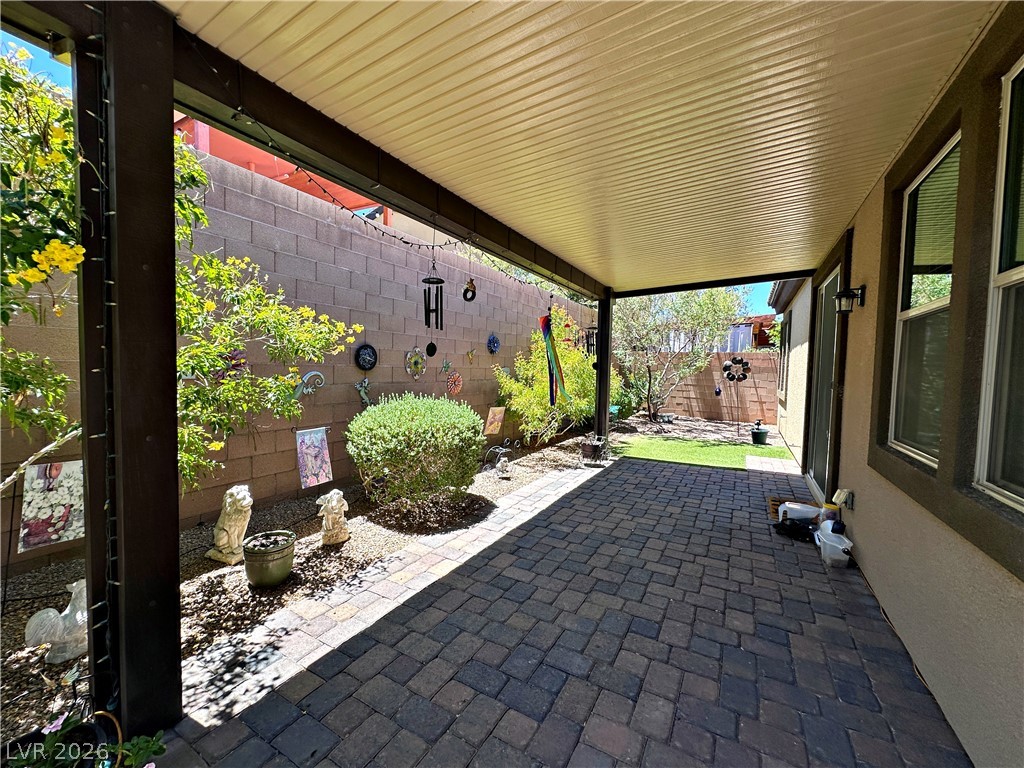 71 Newton Ridge Way Las Vegas, NV 89183 - Photo 37 of 40 An inviting covered patio offers abundant space for outdoor relaxation and entertaining.