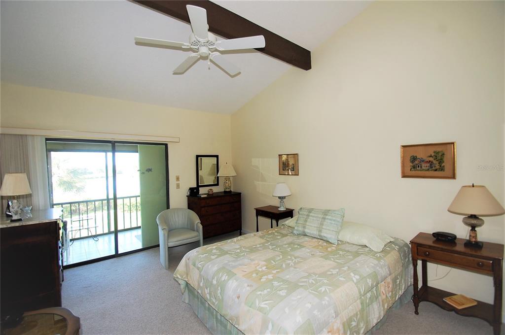 1526 Pelican Point Drive, Unit BA243 Sarasota, FL 34231 - Photo 11 of 24 a bedroom with a bed and wooden floor