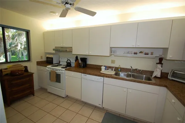 a kitchen with a sink cabinets and window