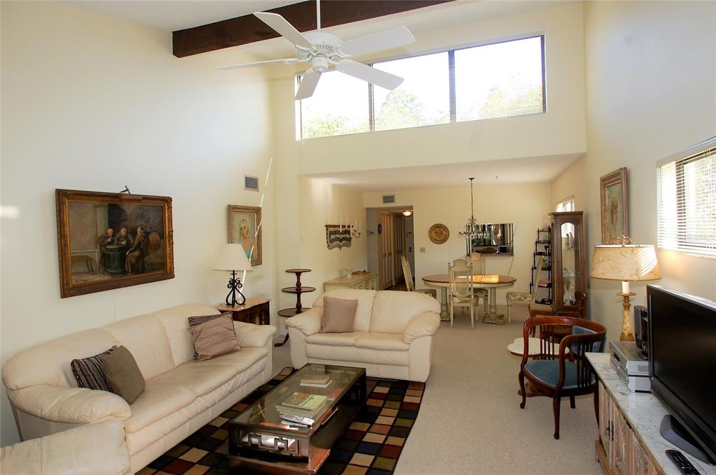 1526 Pelican Point Drive, Unit BA243 Sarasota, FL 34231 - Photo 6 of 24 a living room with furniture and a flat screen tv