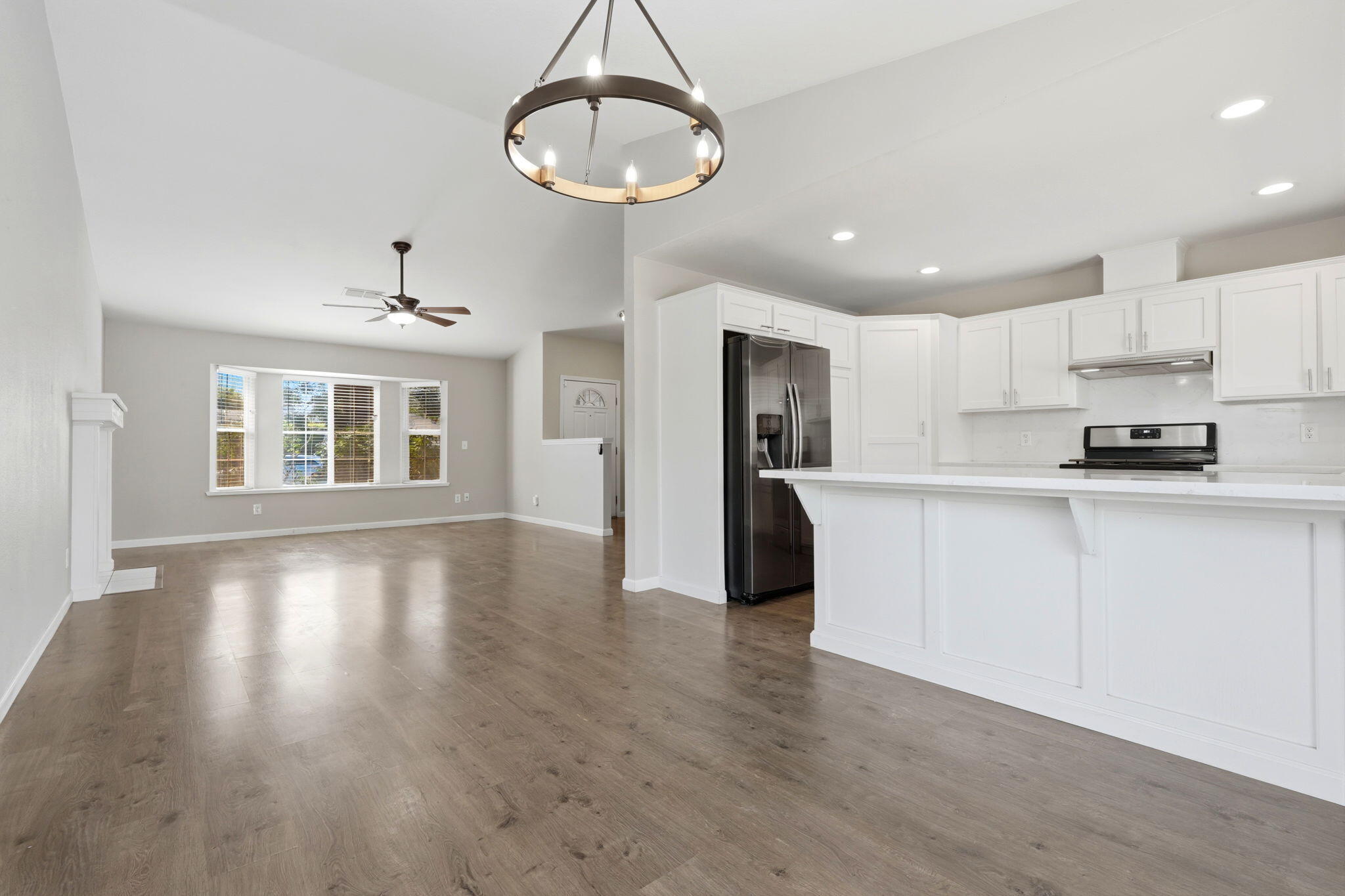 481 Katelyn Court Exeter, CA 93221 - Photo 24 of 33 a kitchen with stainless steel appliances granite countertop a refrigerator a stove a sink dishwasher and white cabinets with wooden floor