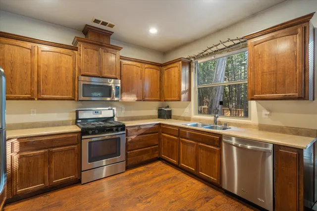 a kitchen with sink a microwave and cabinets