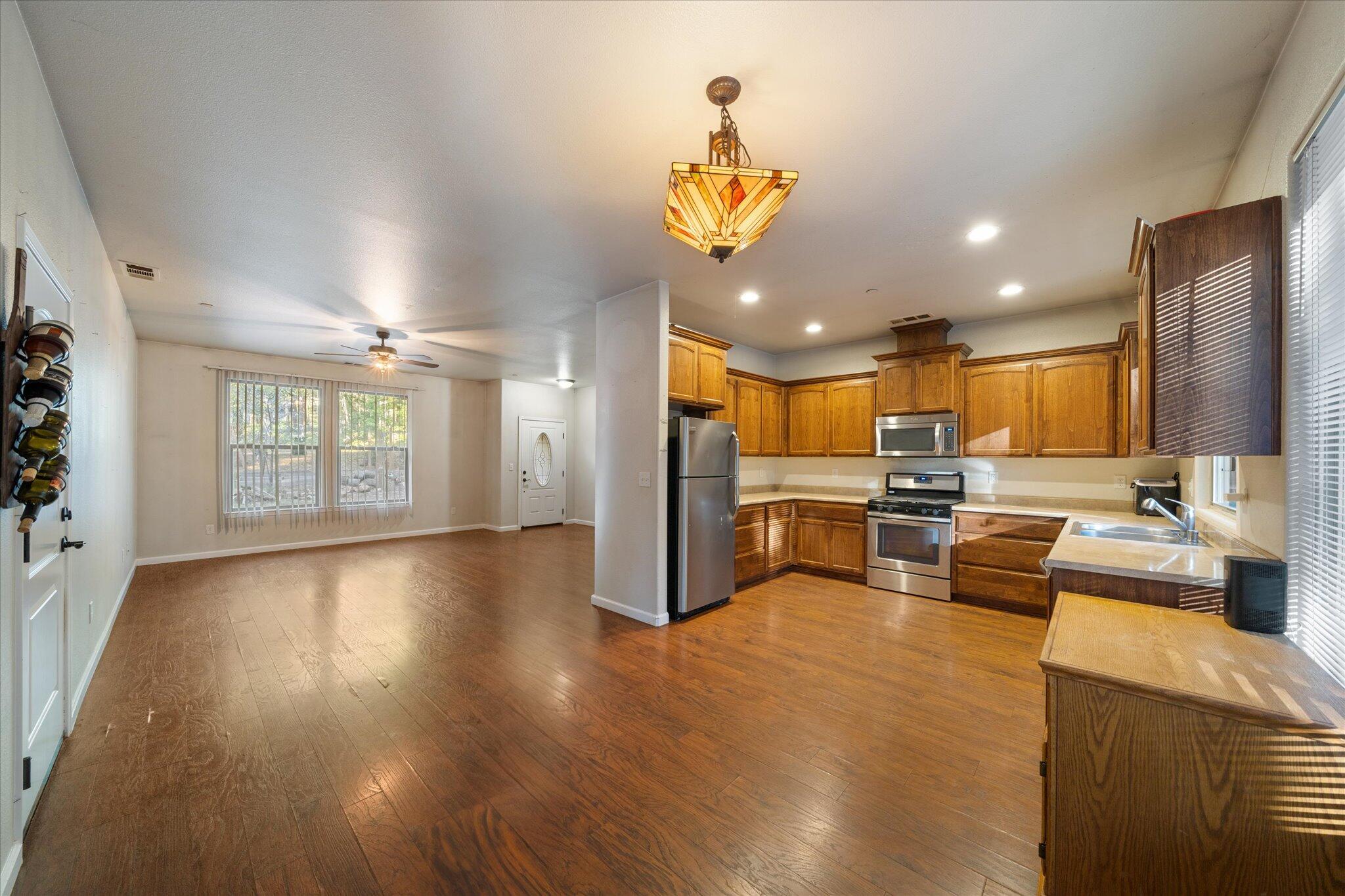 30821 Tinkerbell Lane Shingletown, CA 96088 - Photo 8 of 25 a view of a kitchen with kitchen island stainless steel appliances wooden floor dining table and chairs
