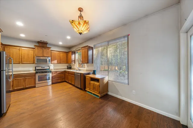 a kitchen with a refrigerator and a stove top oven