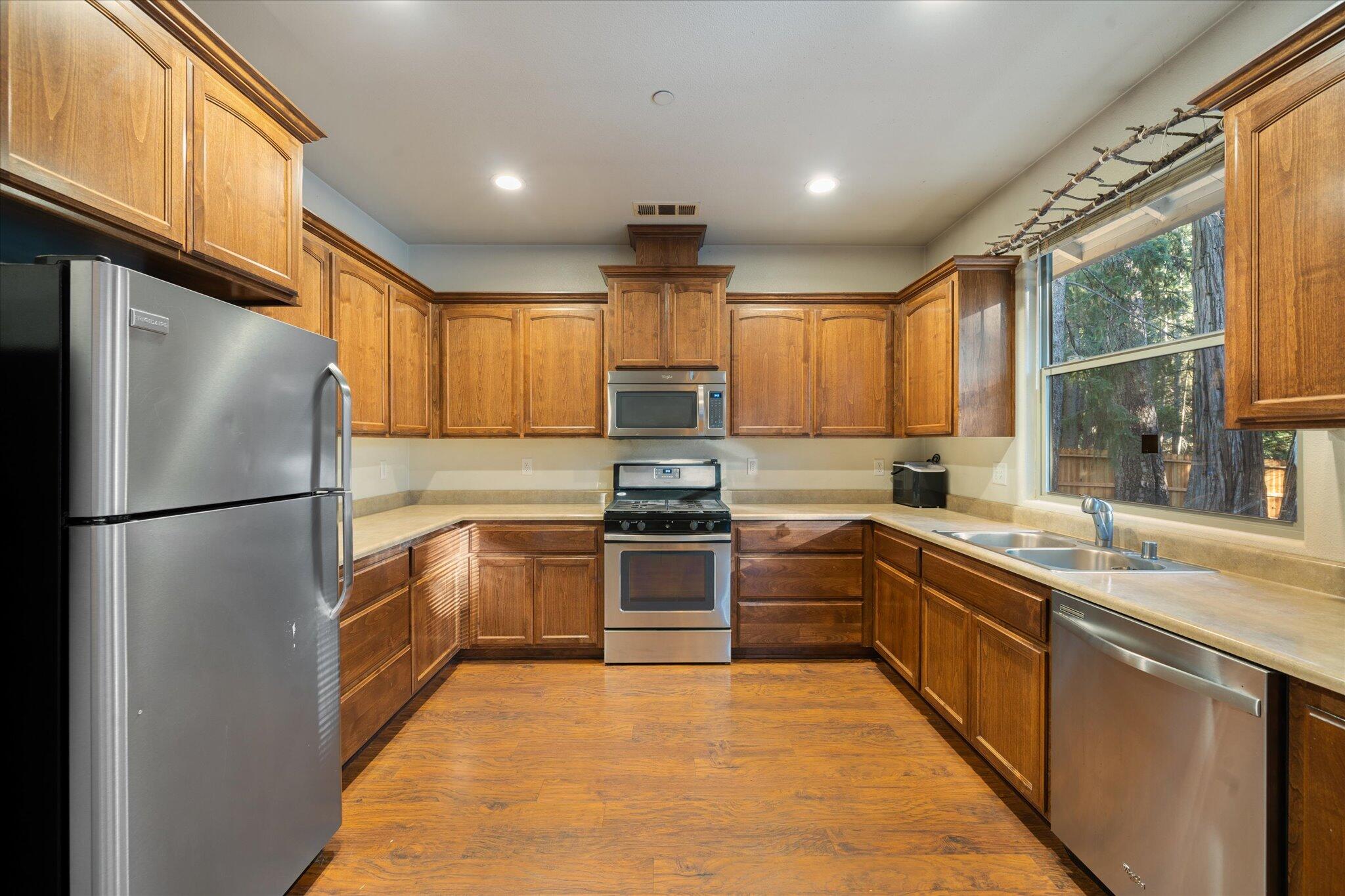 30821 Tinkerbell Lane Shingletown, CA 96088 - Photo 9 of 25 a kitchen with granite countertop stainless steel appliances and window