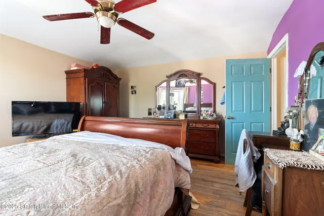 a bedroom with a bed window and a table