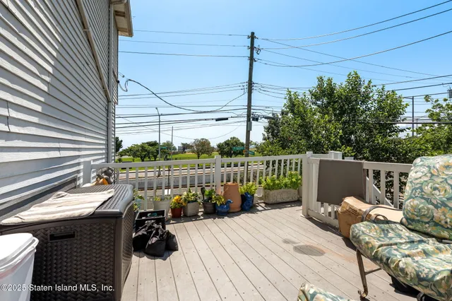 a view of a chair and table in backyard of the house