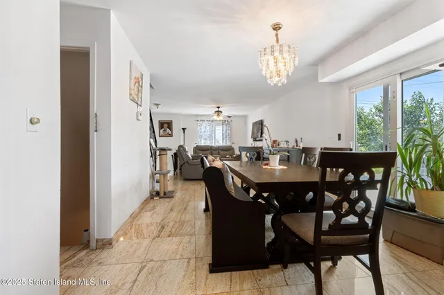 a view of a dining room with furniture and a chandelier