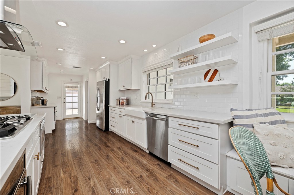7398 Whitegate Avenue Riverside, CA 92506 - Photo 12 of 51 a kitchen with refrigerator cabinets and wooden floor