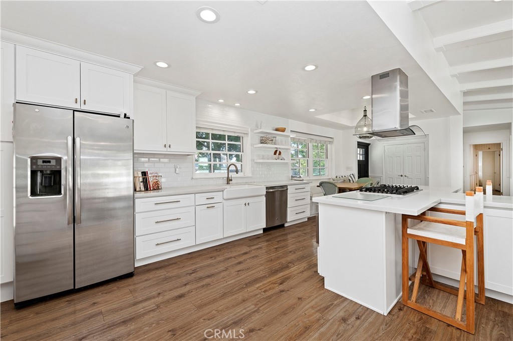 7398 Whitegate Avenue Riverside, CA 92506 - Photo 14 of 51 a kitchen with kitchen island white cabinets and stainless steel appliances