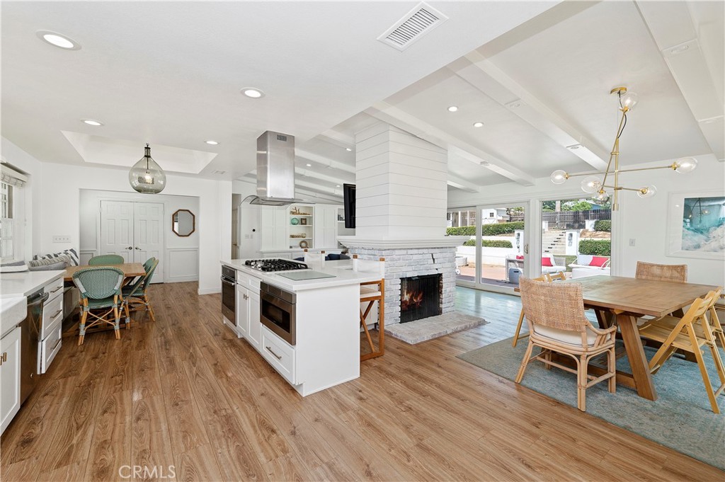 7398 Whitegate Avenue Riverside, CA 92506 - Photo 17 of 51 a kitchen with stainless steel appliances a white table chairs and a stove