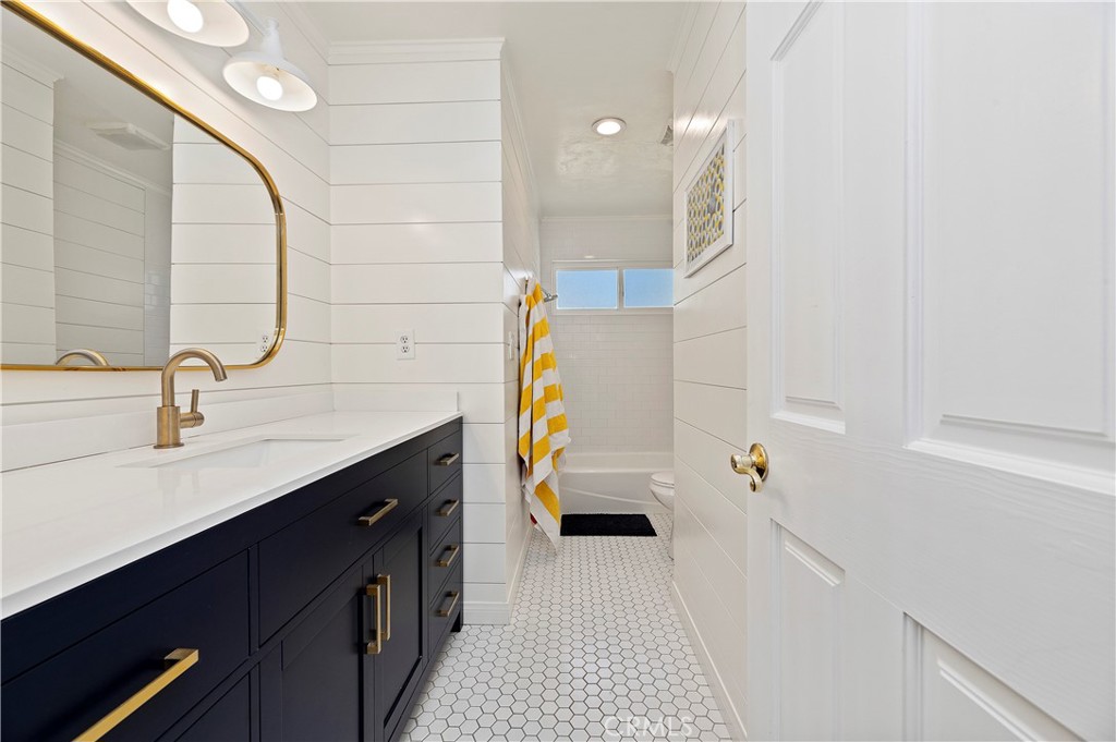 7398 Whitegate Avenue Riverside, CA 92506 - Photo 26 of 51 a bathroom with a sink and mirror