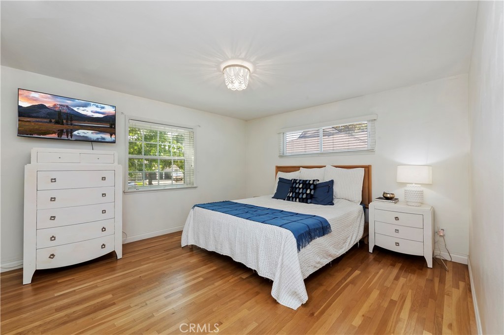 7398 Whitegate Avenue Riverside, CA 92506 - Photo 32 of 51 a bedroom with a bed and a flat screen tv