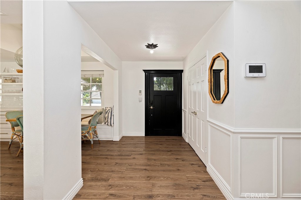 7398 Whitegate Avenue Riverside, CA 92506 - Photo 6 of 51 a view of a hallway with wooden floor and entryway