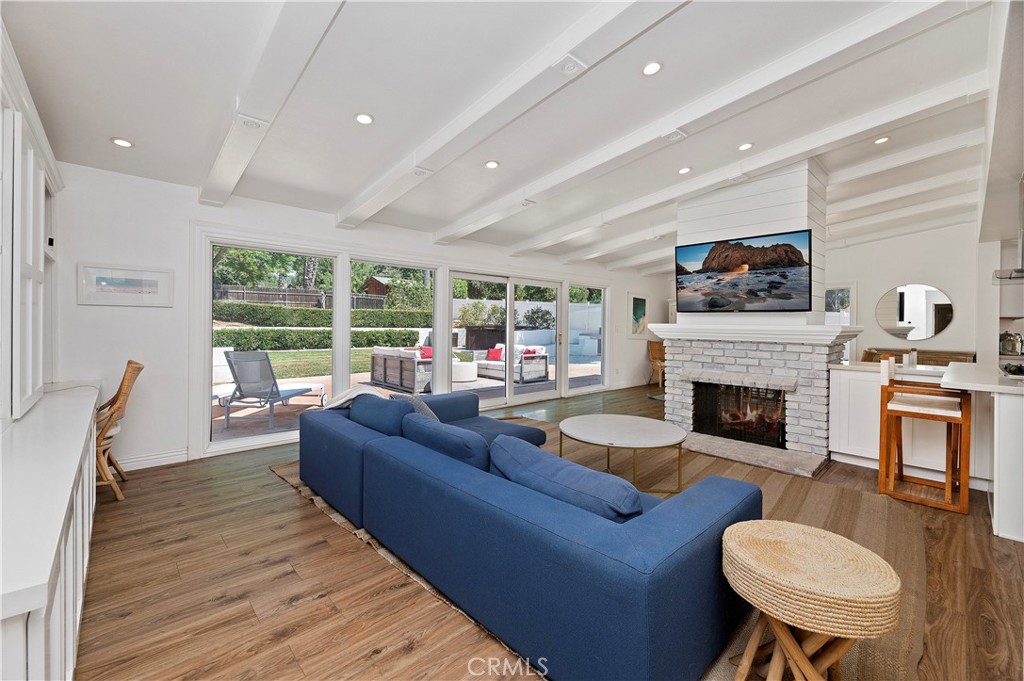 7398 Whitegate Avenue Riverside, CA 92506 - Photo 7 of 51 a living room with furniture a fireplace and a flat screen tv