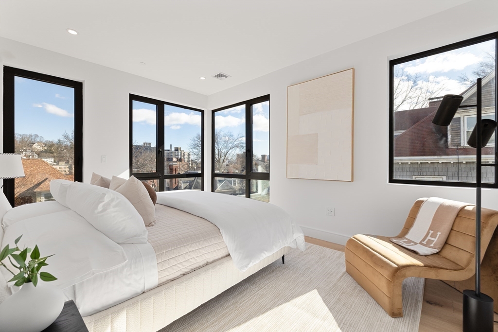 41 University Road, Unit 2 Brookline, MA 02445 - Photo 16 of 33 a spacious bedroom with a bed and a large window