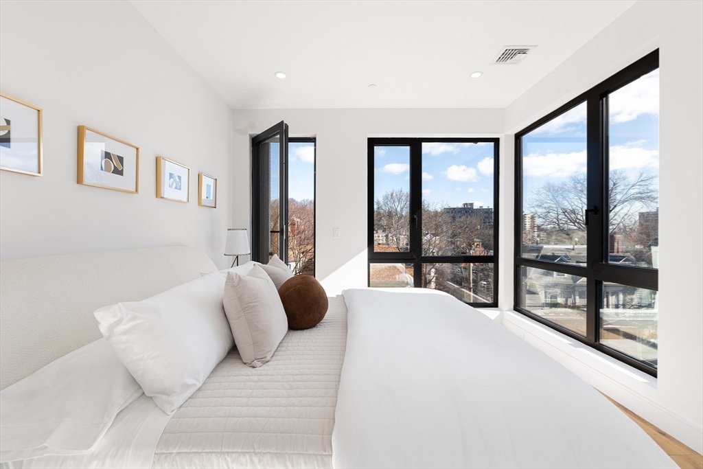 41 University Road, Unit 2 Brookline, MA 02445 - Photo 17 of 33 a bedroom with a large bed and a large window