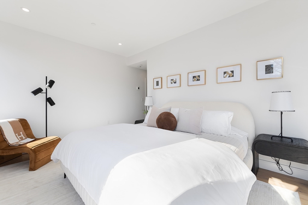 41 University Road, Unit 2 Brookline, MA 02445 - Photo 18 of 33 a bedroom with a bed and a couch