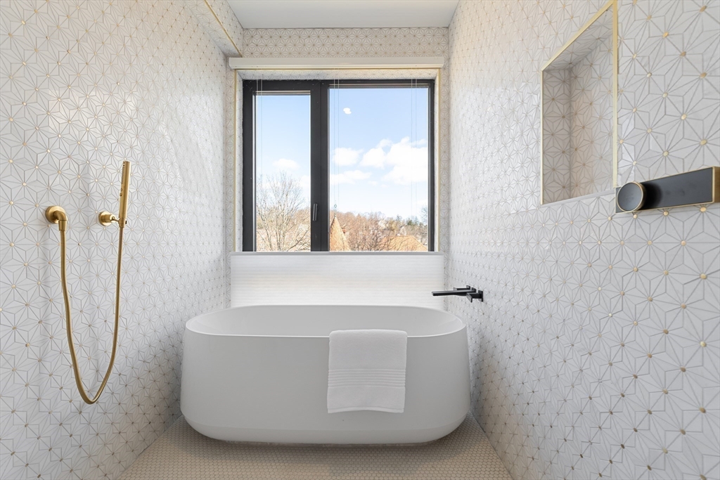 41 University Road, Unit 2 Brookline, MA 02445 - Photo 23 of 33 a white bath tub sitting next to a window