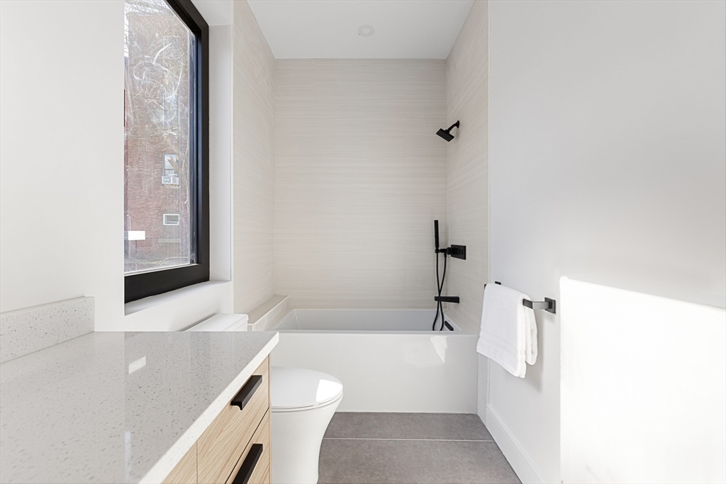 41 University Road, Unit 2 Brookline, MA 02445 - Photo 27 of 33 a bathroom with a toilet a sink and bathtub