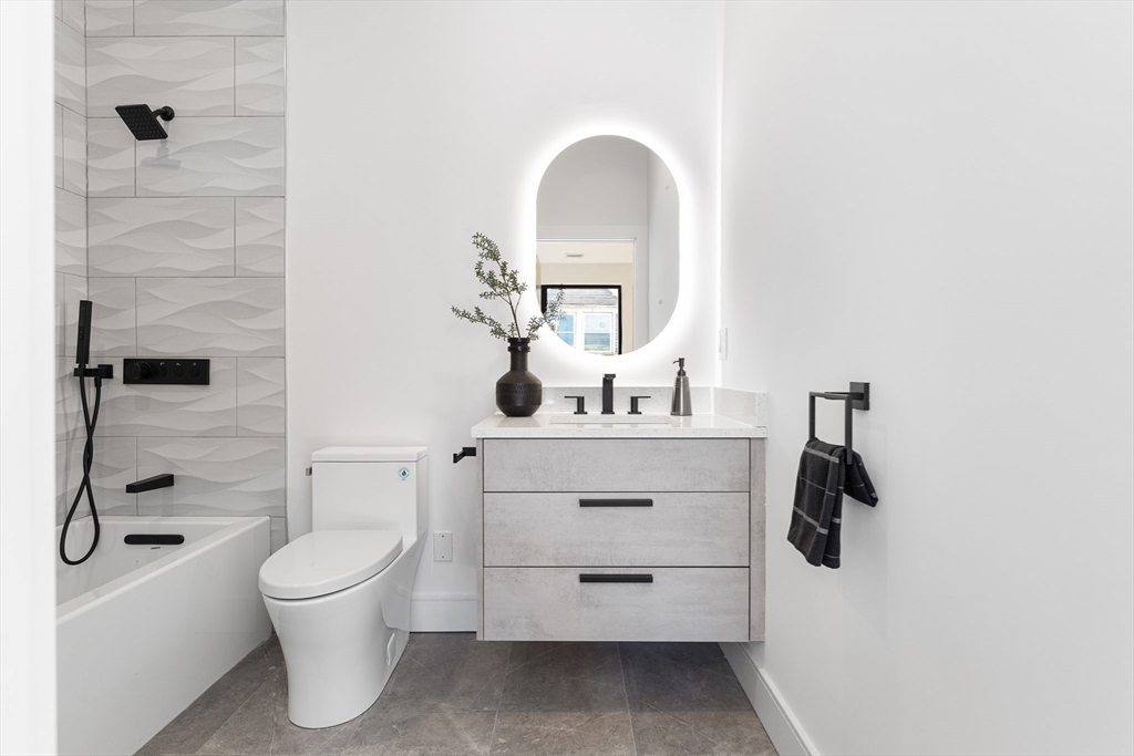 41 University Road, Unit 2 Brookline, MA 02445 - Photo 29 of 33 a bathroom with a toilet sink and mirror