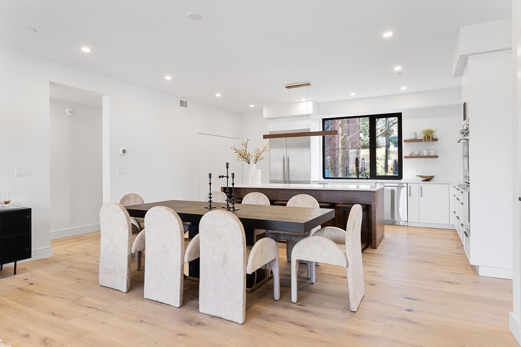 41 University Road, Unit 2 Brookline, MA 02445 - Photo 7 of 33 a view of a dining room with furniture and wooden floor