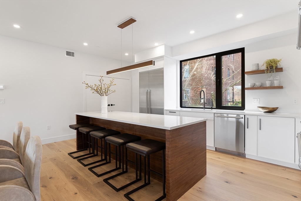 41 University Road, Unit 2 Brookline, MA 02445 - Photo 9 of 33 a kitchen with a sink appliances and cabinets