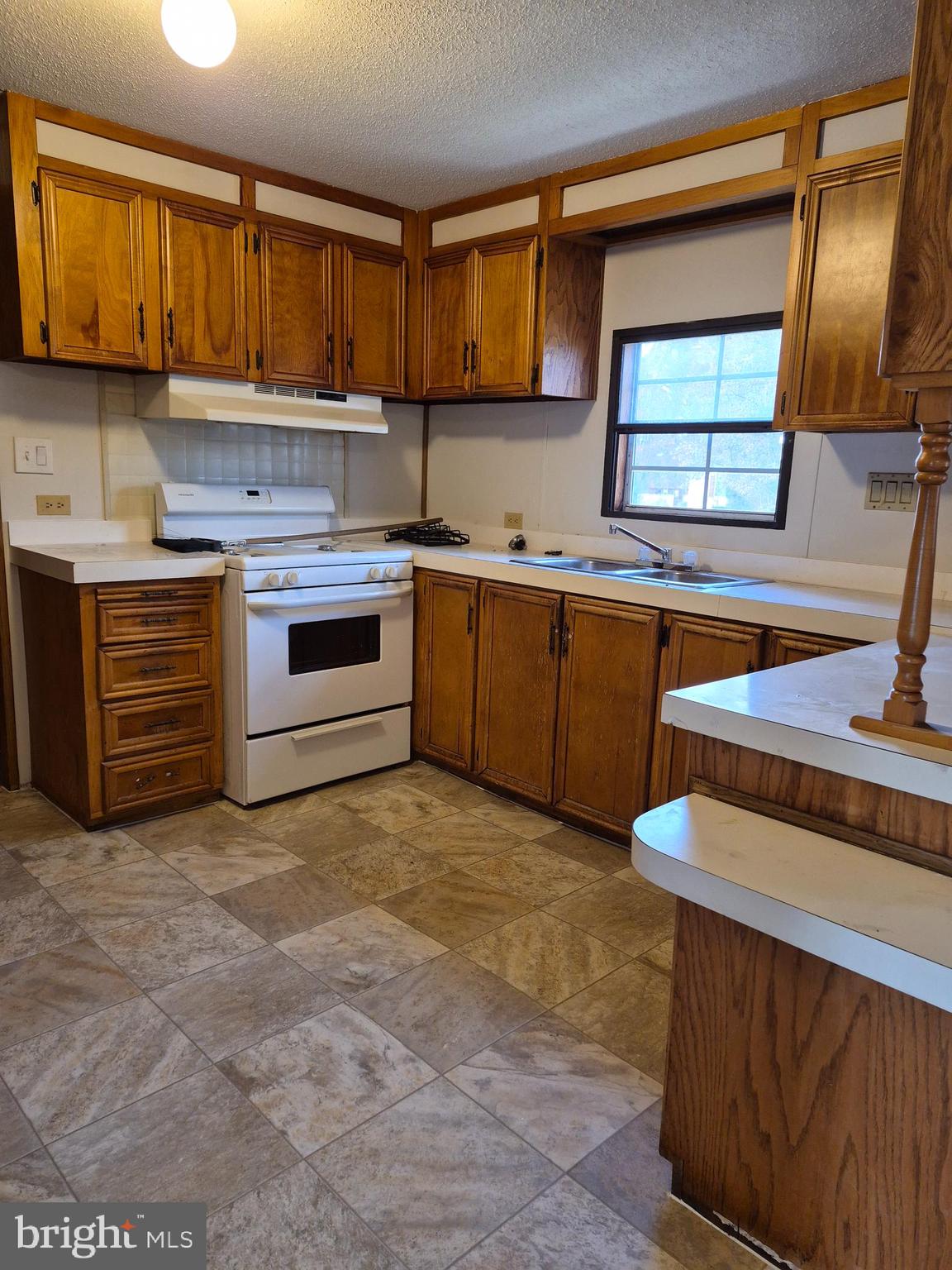 707 Cleaver Farm Road, Unit 707 Middletown, DE 19709 - Photo 7 of 15 a kitchen with stainless steel appliances granite countertop a stove a sink and a microwave