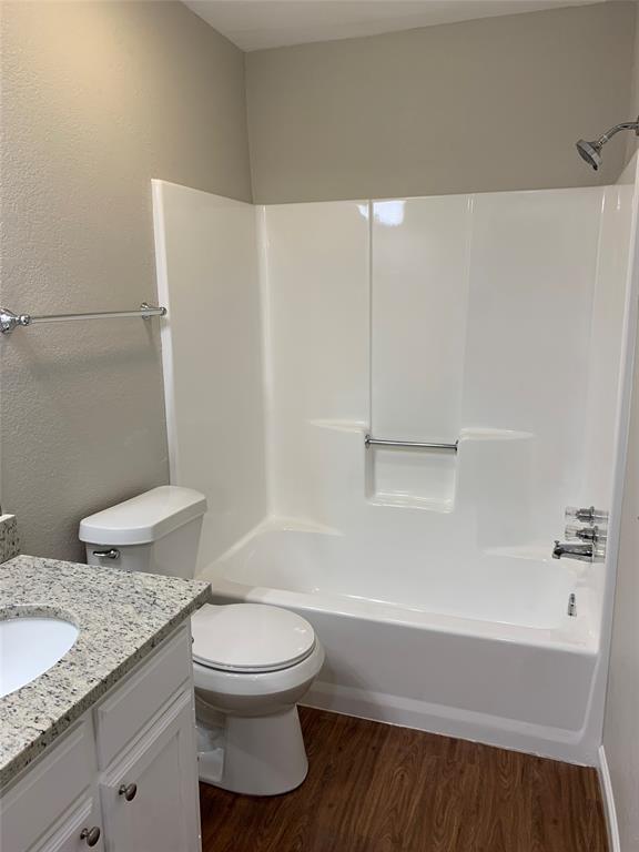 5710 Ranchogrande Drive Arlington, TX 76017 - Photo 8 of 22 a bathroom with a granite countertop toilet and a sink