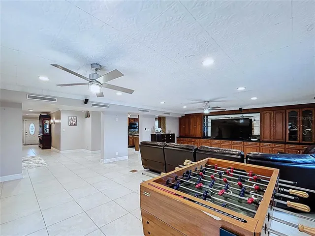 a living room with furniture ceiling fan and a rug