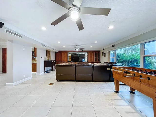 a living room with furniture a fireplace and window