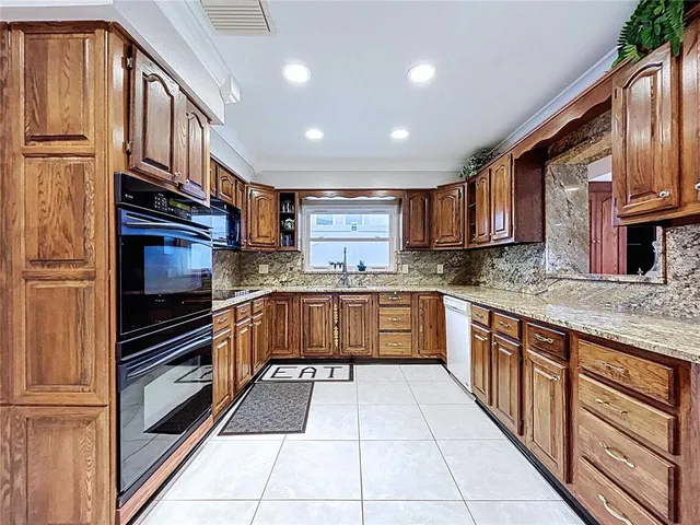 a bathroom with a granite countertop sink mirror vanity and toilet