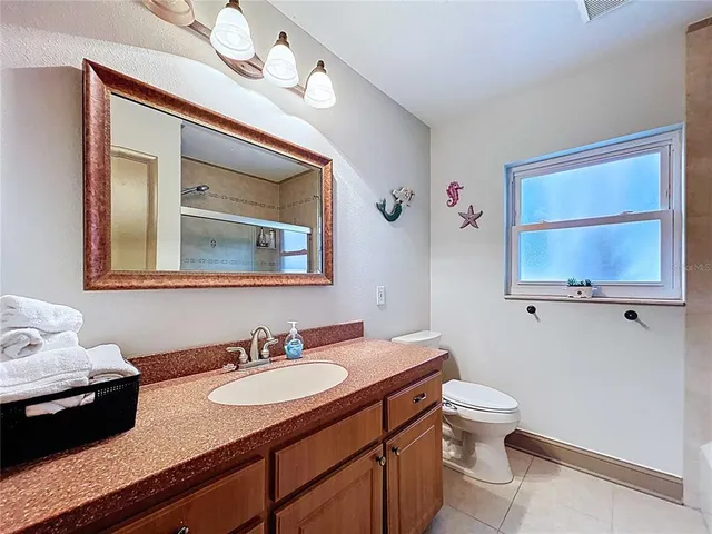 a bedroom with bed and window