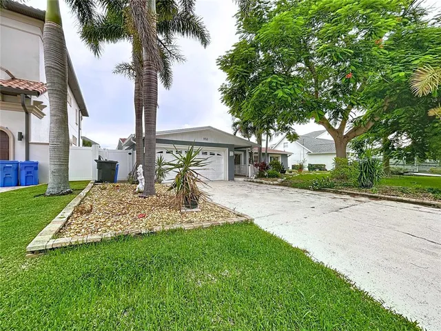a front view of house with yard and green space