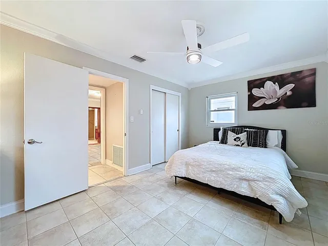 a bed room with a bed and a mirror