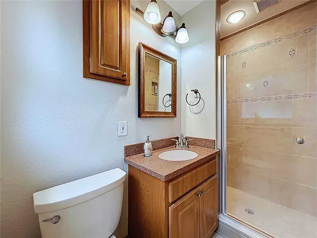a spacious bathroom with a granite countertop sink and a mirror
